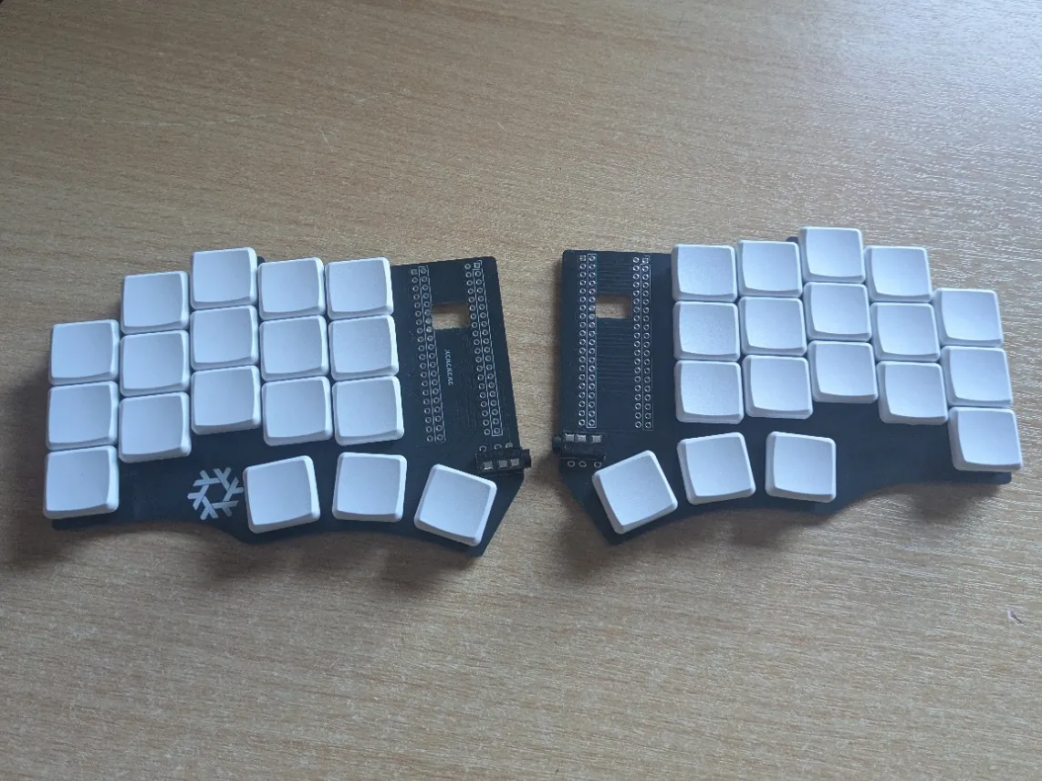 Keyboard parts laid out: switches, microcontroller, TRRS cable